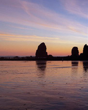 Beachcombers Near Haystack Rock at sunset; location for the film: The Goonies